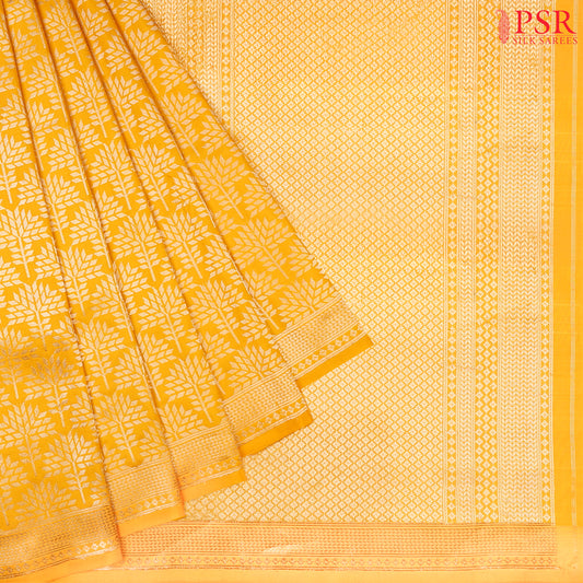 PSR Silk Sarees presents an elegant Amber Yellow Banaras Silk Saree, a masterpiece of heritage and craftsmanship.