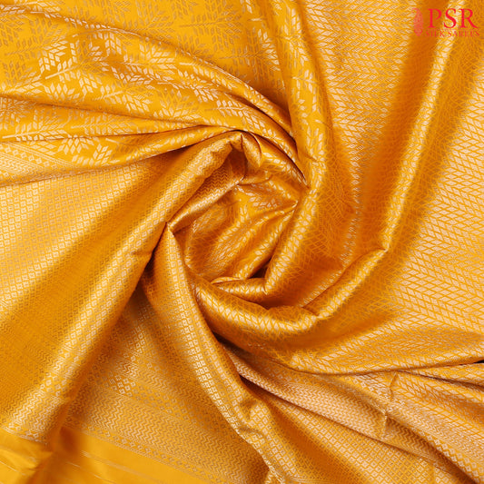 PSR Silk Sarees presents an elegant Amber Yellow Banaras Silk Saree, a masterpiece of heritage and craftsmanship.