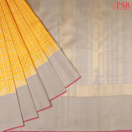 Amber Yellow Kanchipuram Silk Saree with small checkered weave, Taupe Grey zari chit pallu, temple border, and a matching plain Taupe Grey blouse