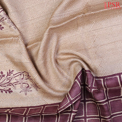 Beige Kadhi Tussar Silk Saree featuring purple floral prints, Olive Grove tessellation designs, and a checkered pallu with a Purple tissue-striped blouse.