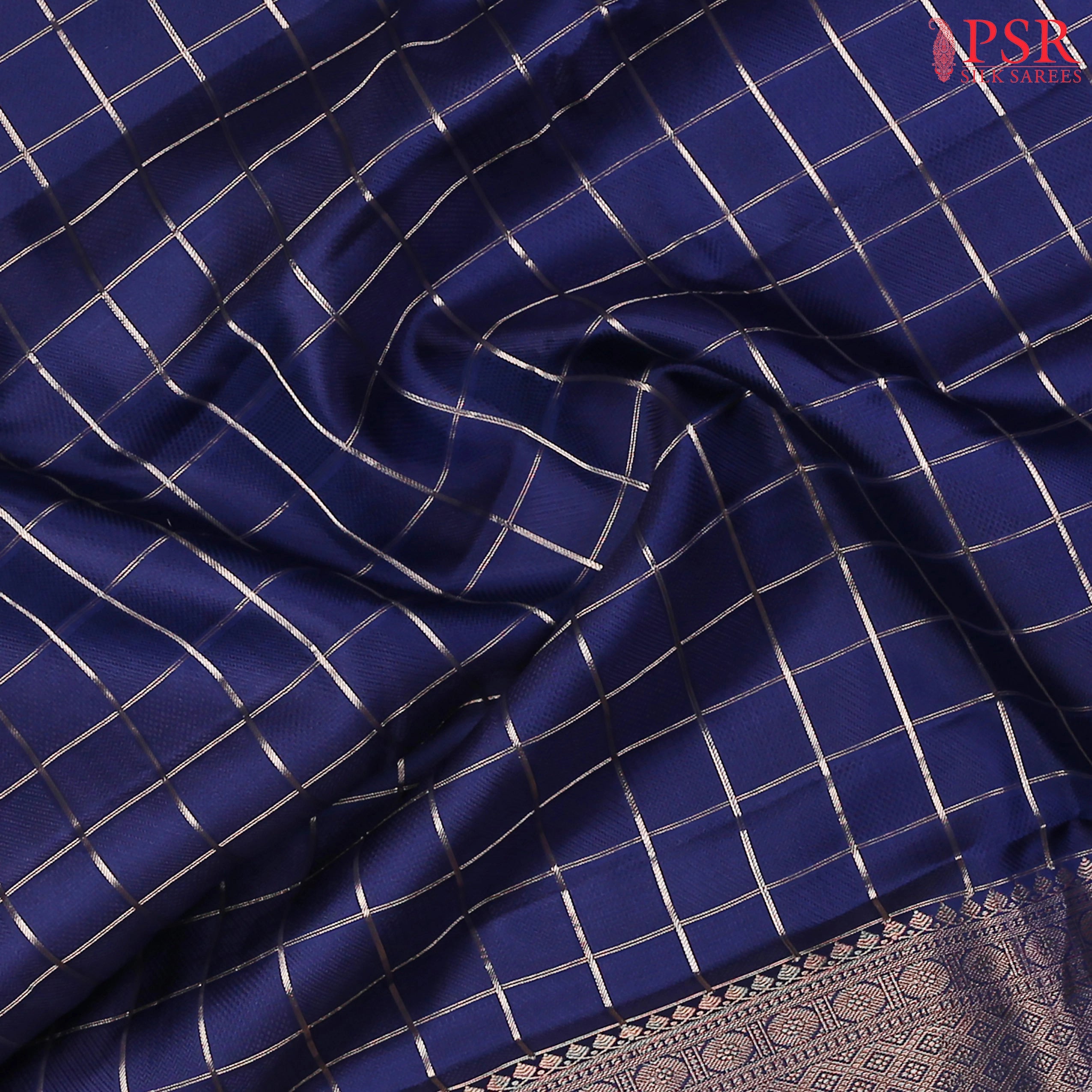 PSR Silks presents a Berry Blue Fancy Kanchipuram Silk Saree, elegantly paired with a zari checkered pattern. A timeless blend of tradition and grace!