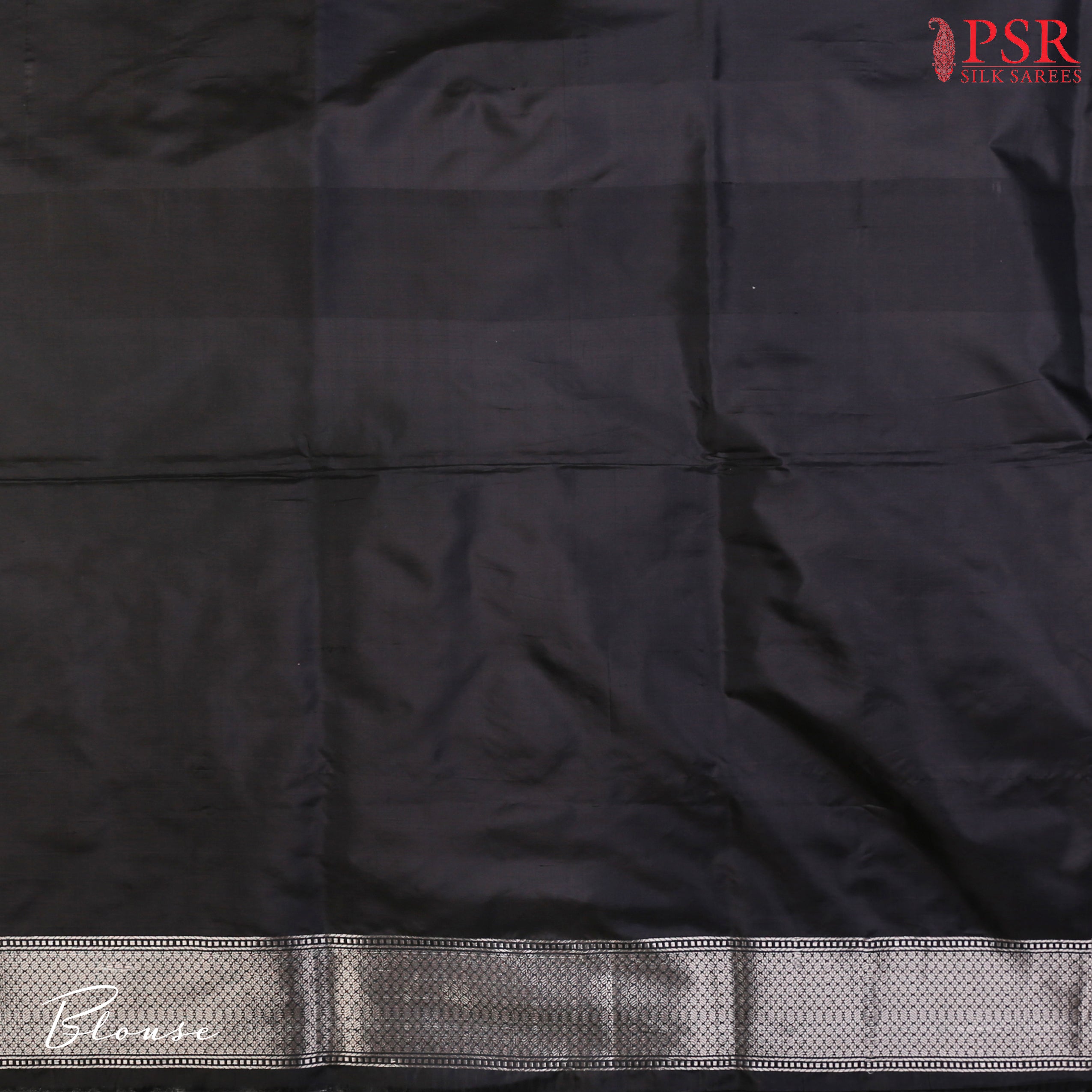 PSR Silks presents a charming Black Banarasi Silk Saree, featuring a beautifully woven floral ogee jacquard pattern crafted with exquisite silver zari.