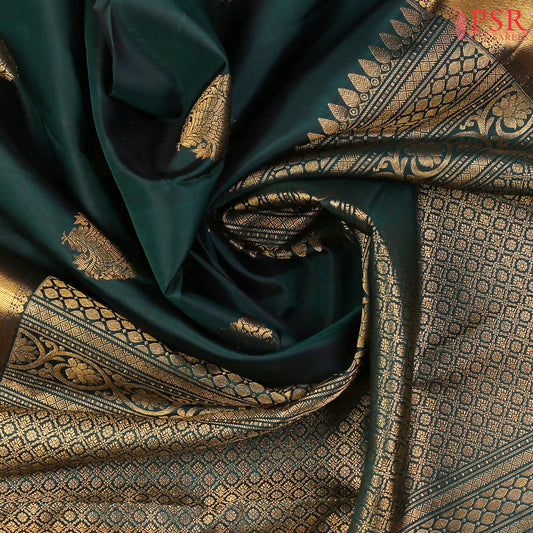 This Bottle Green Kanchipuram Silk Saree from PSR Silk Sarees is a graceful addition to the Smartika Kanjivaram collection.