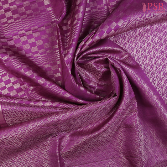 Indulge in timeless elegance with our Byzantium Purple&nbsp;Soft Silk Saree, crafted to perfection with&nbsp;impressive copper zari jacquard geometrical plaids. 