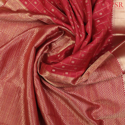 PSR Silks presents a Carmine Red Fancy Kanchipuram Silk Saree, elegantly paired with a zari checks pattern. A timeless blend of tradition and grace