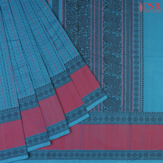 PSR Silks presents a traditionsal handloom Kalakshetra Kovai Cotton saree in a captivating Cerulean Blue, beautifully weaved pink &amp; black thread work.