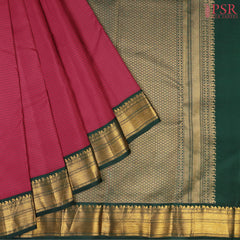 PSR Silks presents a Dark Cerise Pink Fancy Kanchipuram Silk Saree, elegantly paired with a striking Dark Green combination. A timeless blend of tradition and grace!