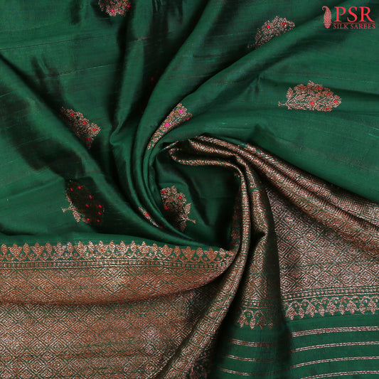 PSR Silks proudly presents a regal Dark Green&nbsp;Banaras Jute Silk Saree, paired with a rich Red&nbsp;combination.