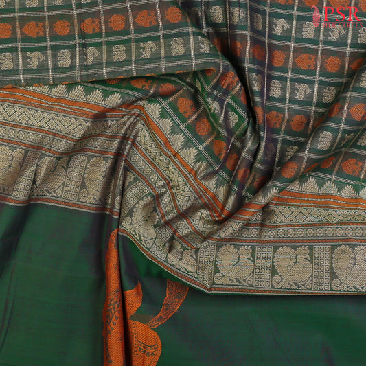 PSR Silks presents a traditional handloom Kalakshetra Kovai Cotton saree in a captivating Dark Green beautifully weaved with beige & orange thread work.