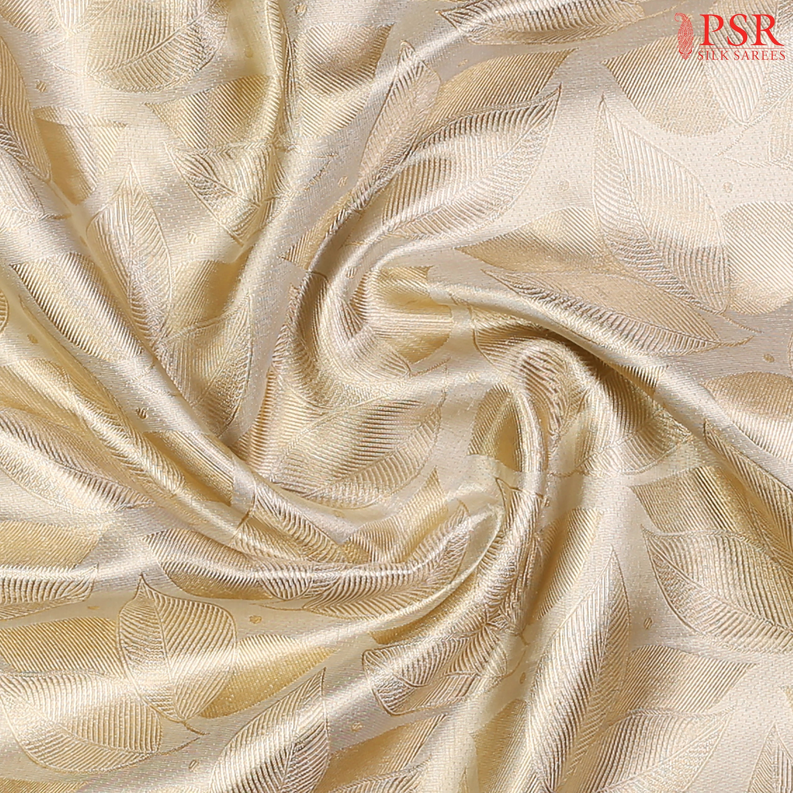 Beige Kanchipuram Silk Saree with a golden leaves jacquard pattern, rich zari pallu & border, and a designer zari work blouse—perfect for festive elegance.