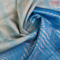 Indulge in the timeless beauty of our Haze Blue Kora Soft Silk Saree, gracefully paired with a Chintamani Blue contrast. 