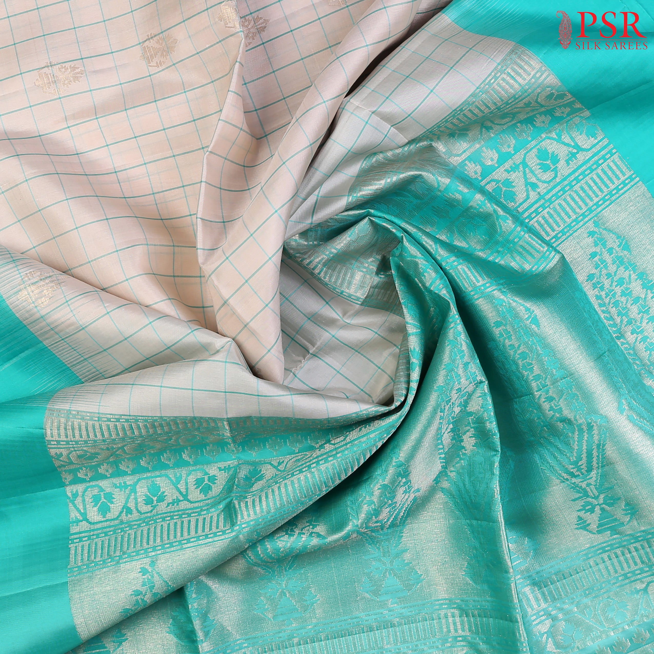 Step into sophistication with our Light Beige Soft Silk Saree, gracefully paired with an exquisite Turquoise contrast. 