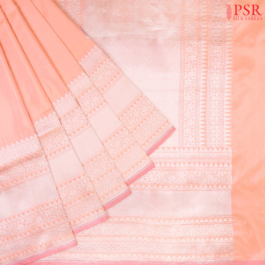 Discover the timeless charm of our Melon Peach Banarasi Katan Silk Saree, paired gracefully with a soothing Light Pink combination.