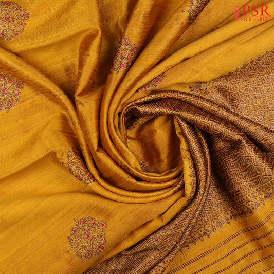 PSR Silks proudly presents a regal Mustard Yellow Banaras Jute Silk Saree, paired with a rich Red combination