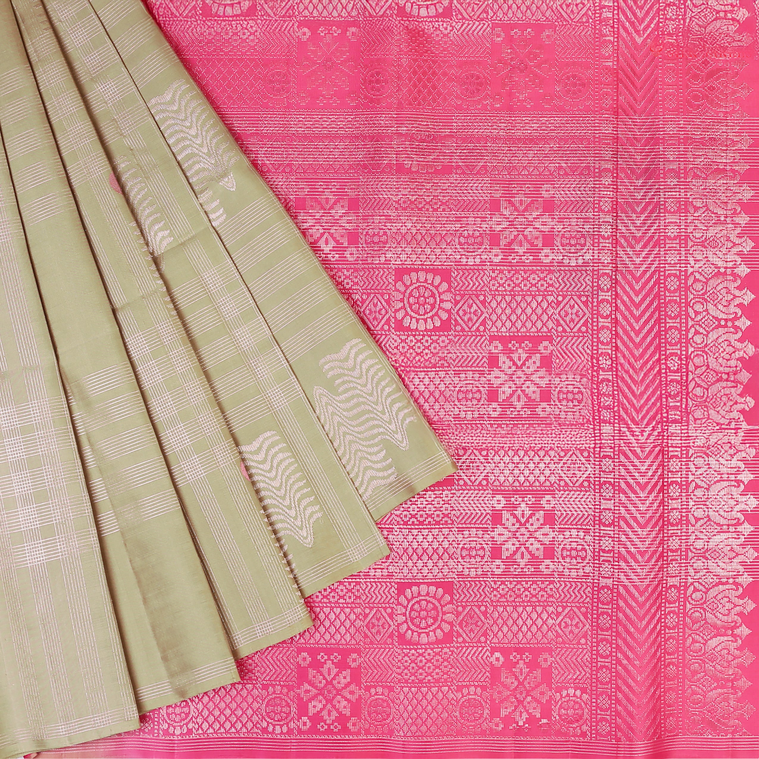 Drape yourself in contemporary grace with our Olive Mist Soft Silk Saree, beautifully contrasted with a vibrant Pink hue.