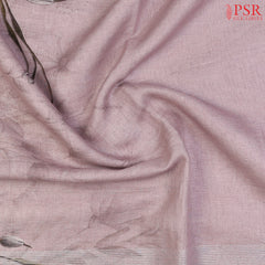 Pastel Mauve Linen Saree featuring delicate floral prints, a floral printed pallu with tissue stripes, and a matching floral printed blouse.