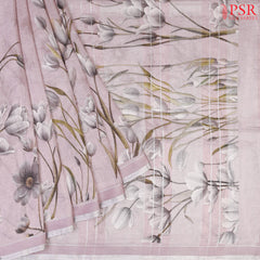 Pastel Mauve Linen Saree featuring delicate floral prints, a floral printed pallu with tissue stripes, and a matching floral printed blouse.