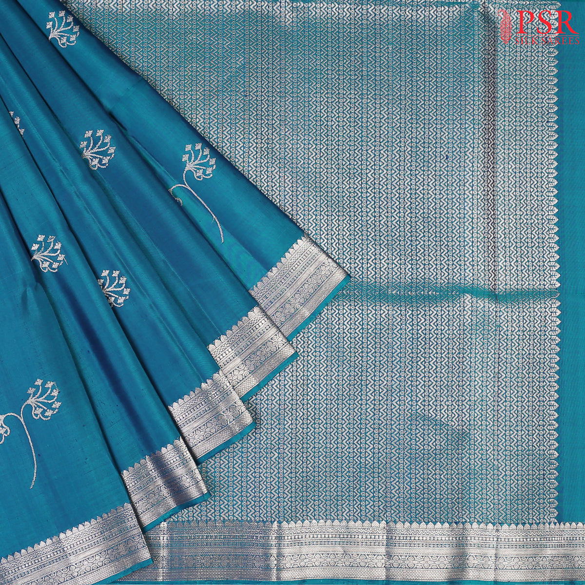  Drape yourself in the majestic charm of our Peacock Blue Soft Silk Saree, a celebration of tradition and beauty. 