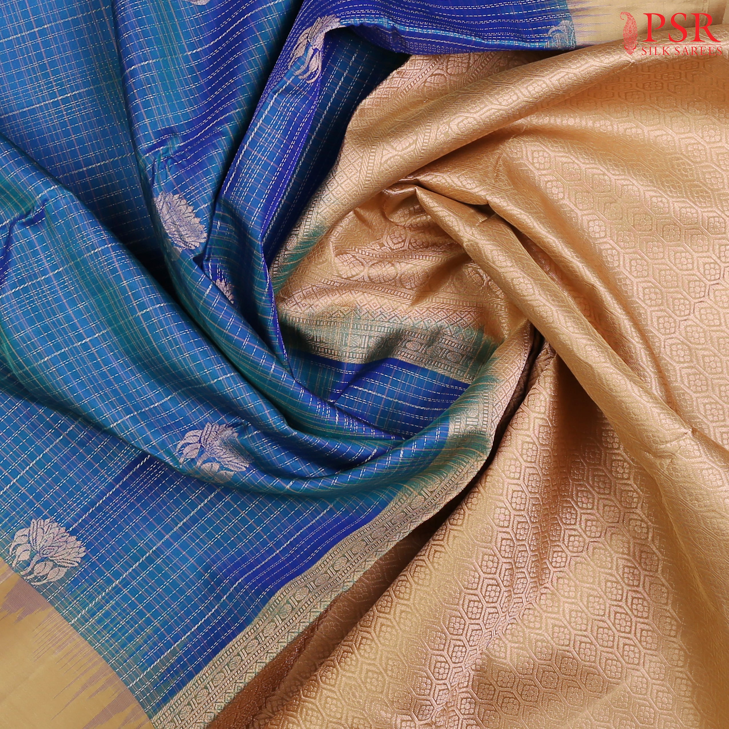 Elevate your ethnic elegance with our Peacock Blue Soft Silk Saree, gracefully paired with a rich Tan contrast