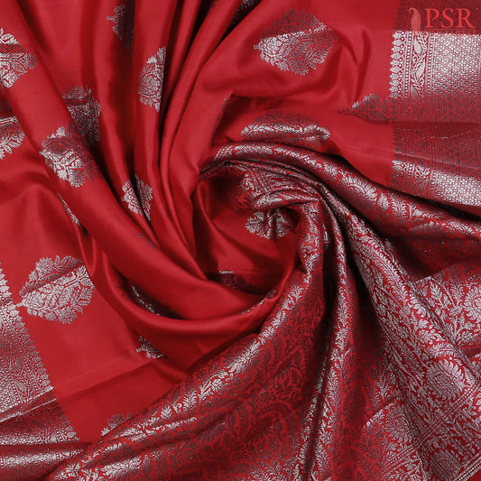 Red Chiniya Silk Saree, a timeless masterpiece adorned with silver zari floral brocade motifs. 