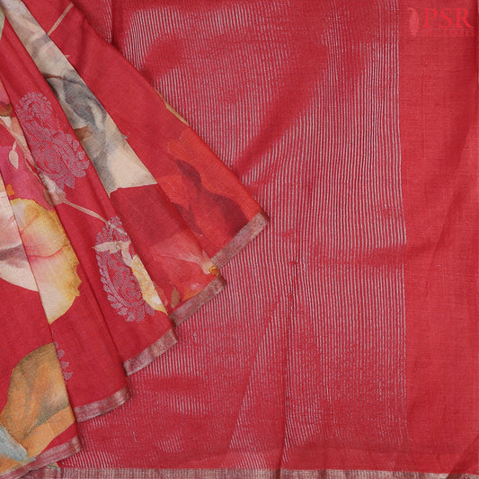 Red Kadhi Tussar Silk Saree featuring colorful floral prints, silver zari paisley motifs, a matching silver zari striped pallu, and a plain blouse—perfect for festive elegance.