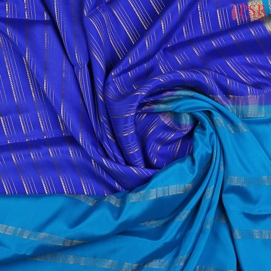 Indulge in the richness of PSR Silks' Royal Blue Mysore Silk saree, paired beautifully with a vibrant Cerulean Cyan combination