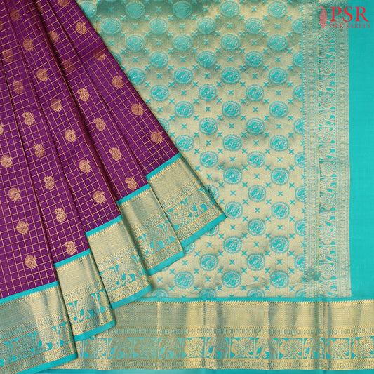 PSR Silks presents a Seance Purple Fancy Kanchipuram Silk Saree, elegantly paired with a striking Persian Green combination. A timeless blend of tradition and grace!