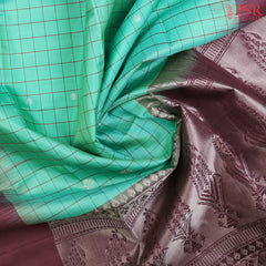 Embrace elegance with our Spring Green Soft Silk Saree, beautifully complemented by an Umber Brown combination. 