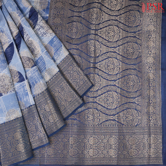 Drape yourself in sophisticated charm with our Steel Blue Chiniya Silk Saree, beautifully paired with Prussian Blue for a royal touch.