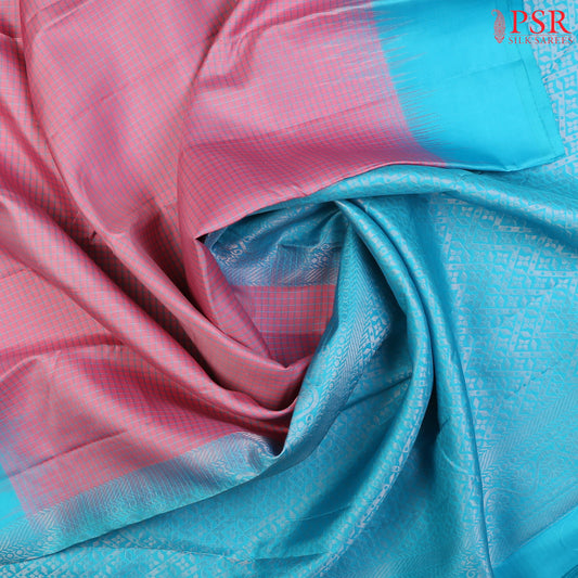 PSR Silks presents a Taffy Pink Fancy Kanchipuram Silk Saree, elegantly paired with a striking Turquoise Blue combination. A timeless blend of tradition and grace