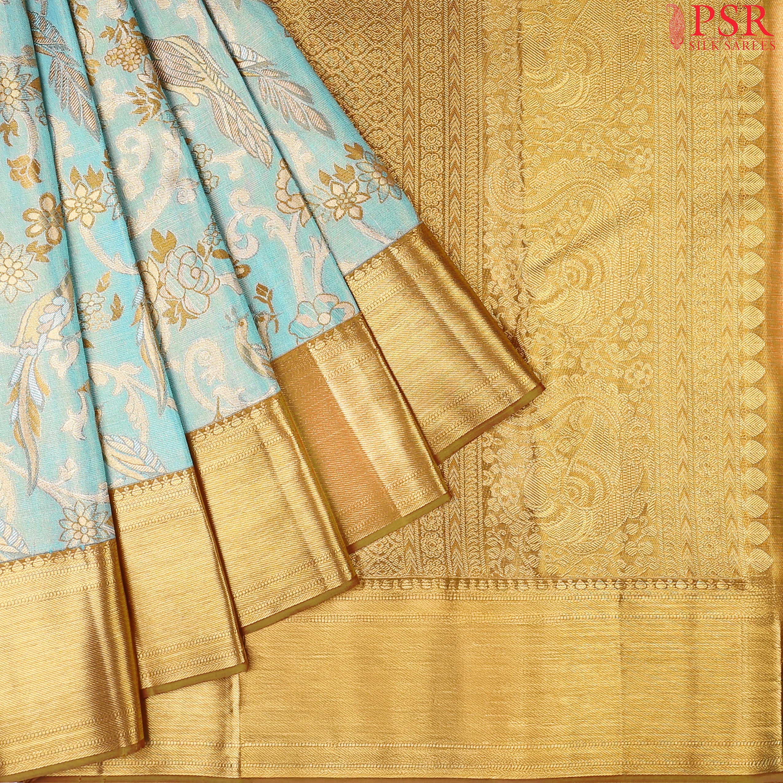 Turquoise Blue Kanchipuram Tissue Silk Saree with floral scroll zari weaves and bird motifs, paired with a Dark Mustard zari pallu, border, and tissue blouse.