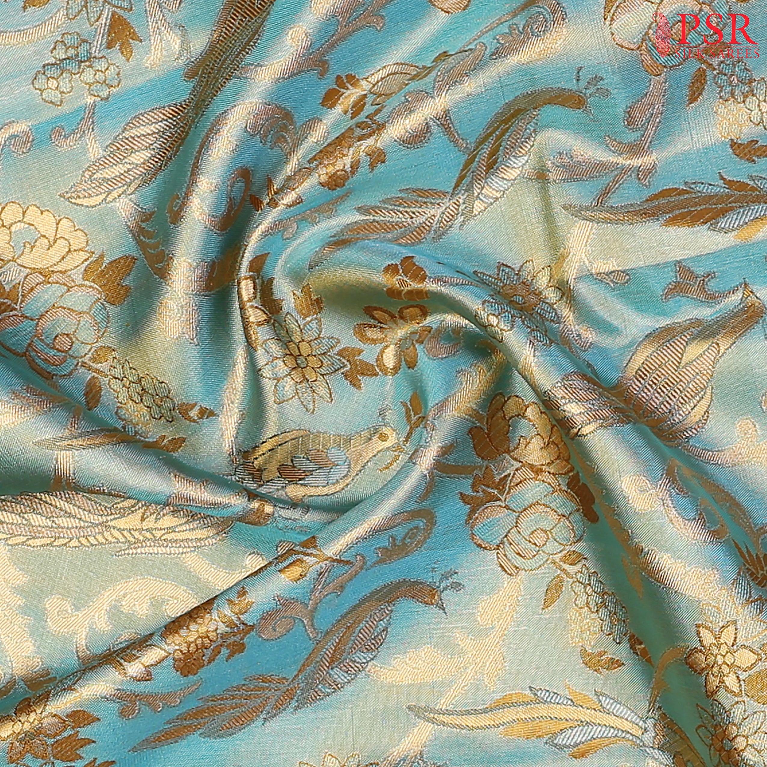 Turquoise Blue Kanchipuram Tissue Silk Saree with floral scroll zari weaves and bird motifs, paired with a Dark Mustard zari pallu, border, and tissue blouse.