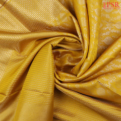 This Tuscan Yellow &amp; Brown Kanchipuram Silk Saree from PSR Silk Sarees is a timeless masterpiece from the "Vaichitrya Kanjivaram" collection