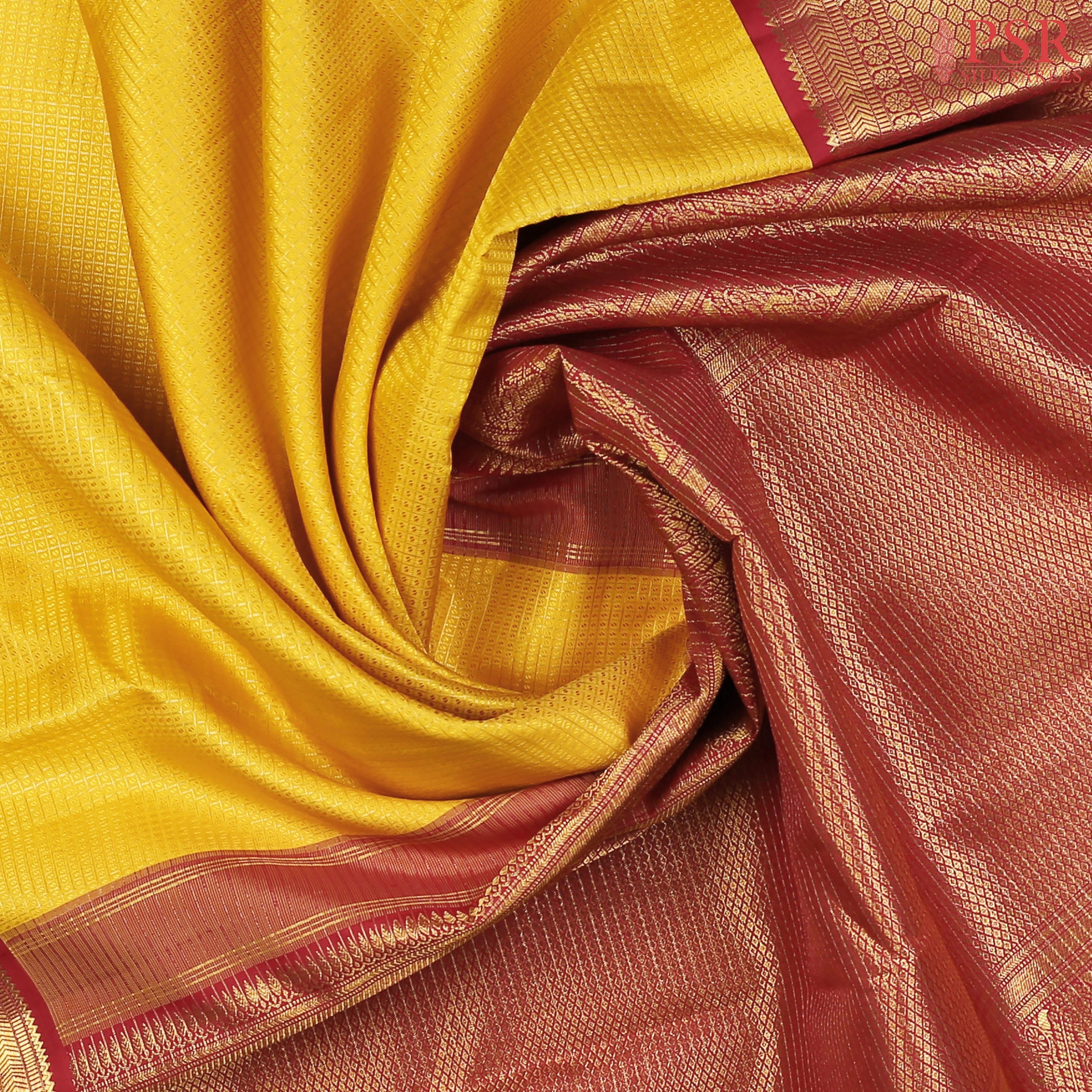 This Yellow & Maroon Kanchipuram Silk Saree from PSR Silk Sarees is a captivating addition to the Vaichitraya Kanjivaram collection